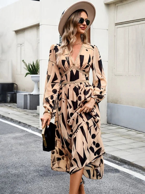 Beige midi dress with black abstract print, v-neck, and ruffled skirt.
