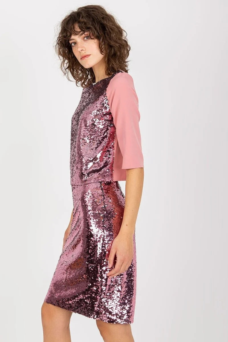 Pink sequined top with solid pink quarter sleeves on a model.