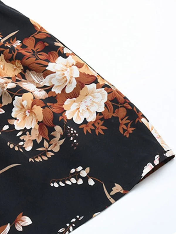 Black day dress with a vibrant floral print in shades of cream, tan, and rust.