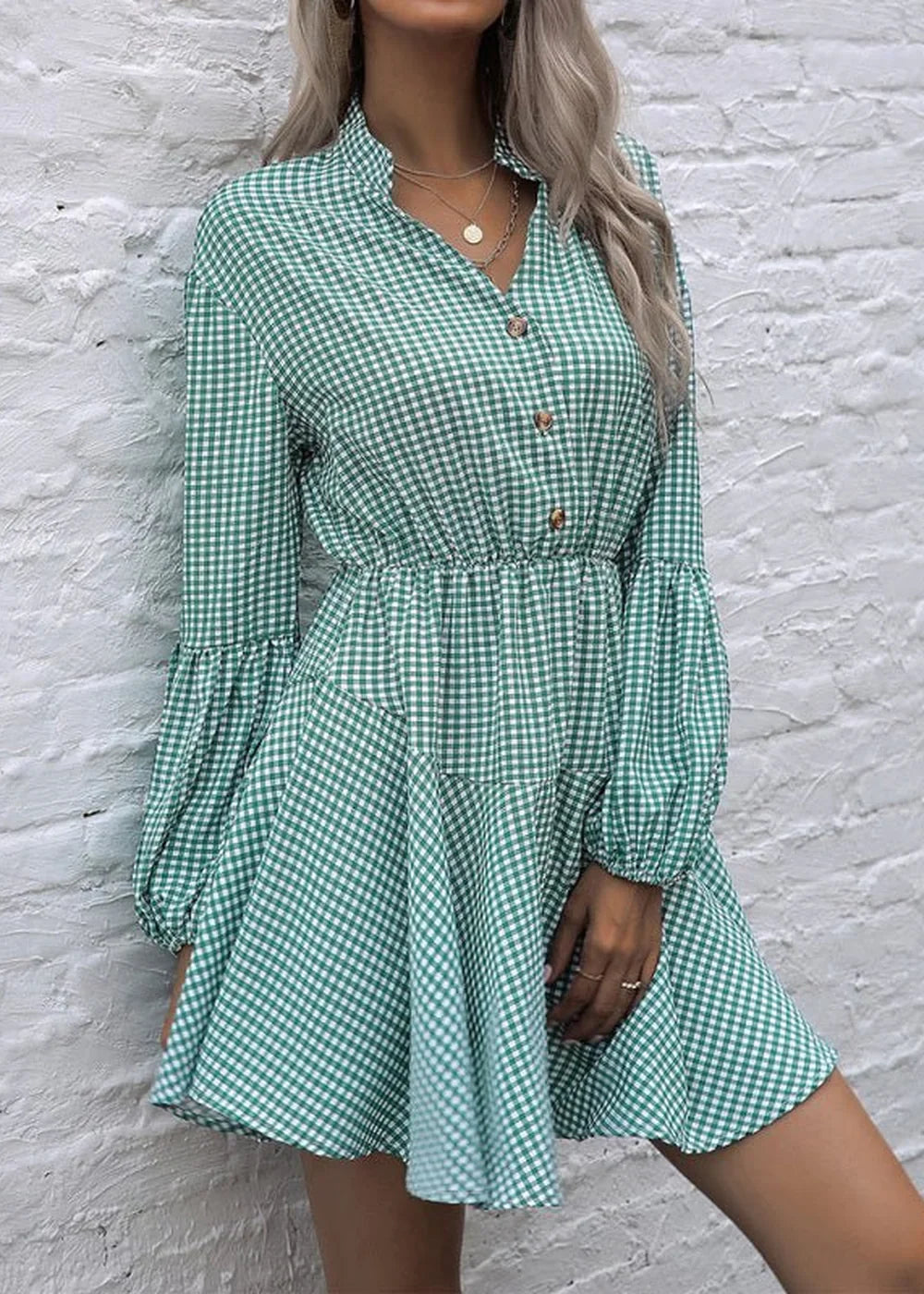 Green and white gingham print dress with a cinched waist and balloon sleeves, shown on a model.