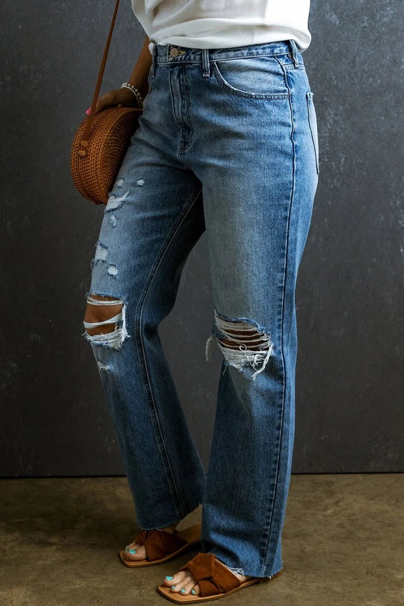 Distressed medium wash denim jeans with ripped knees and a relaxed fit.