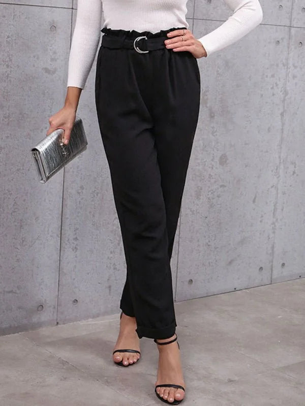 Black paperbag waist pants with a silver buckle belt and cuffed hems.