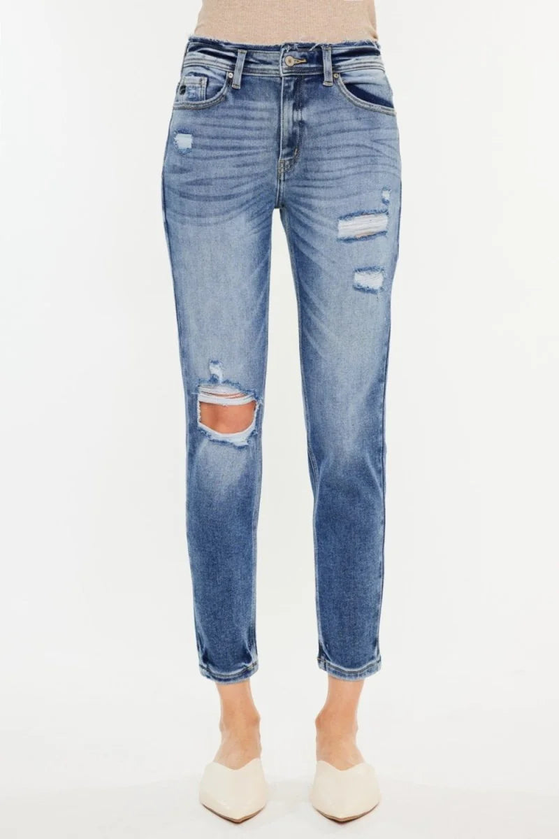 Medium wash distressed denim jeans with ripped details, slight stretch, and a cropped ankle.