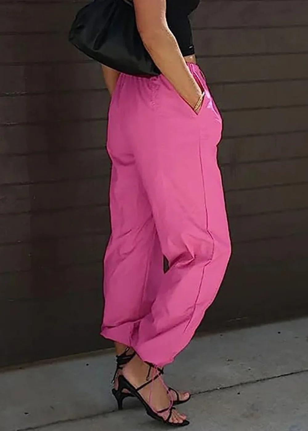 Hot pink polyester pants with elastic waist, side pockets, and tie-up heels.