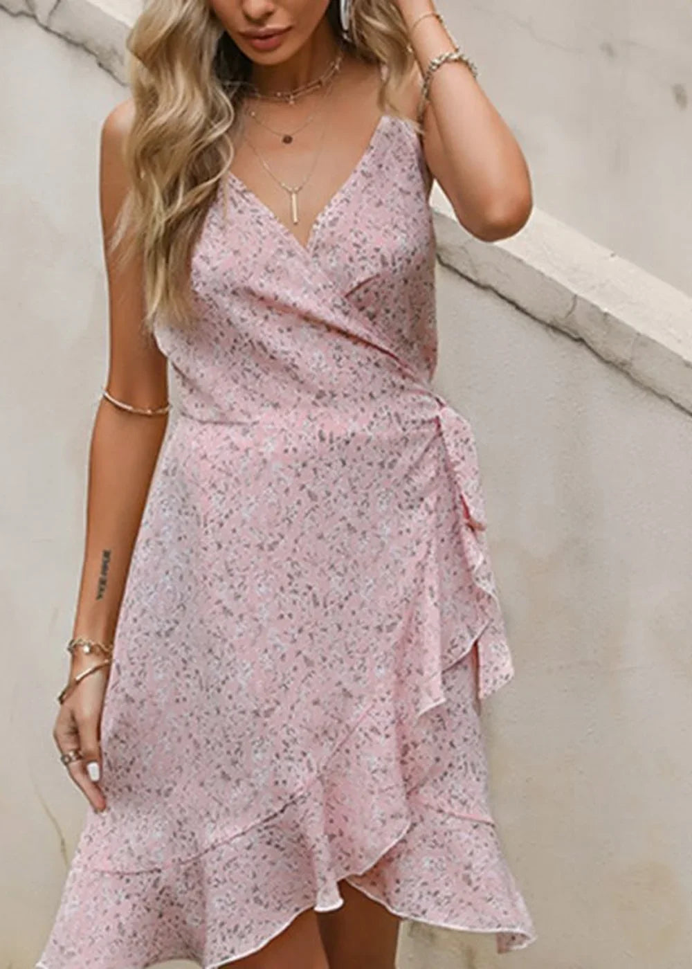 Pink floral print wrap dress with ruffled hem and V-neck.