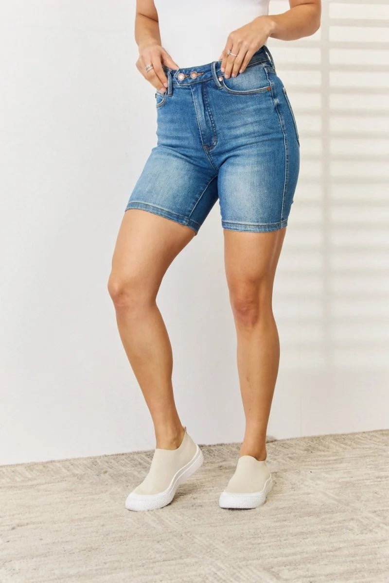 Light wash denim biker shorts with a high waist and slight stretch, shown on a model.