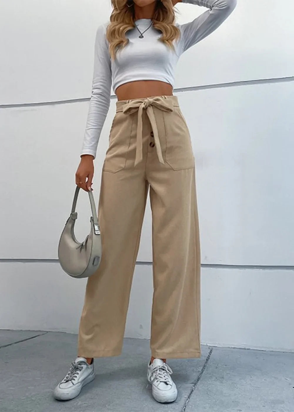 Khaki wide-leg pants with a tie waist, button closure, and pocket details on a model.