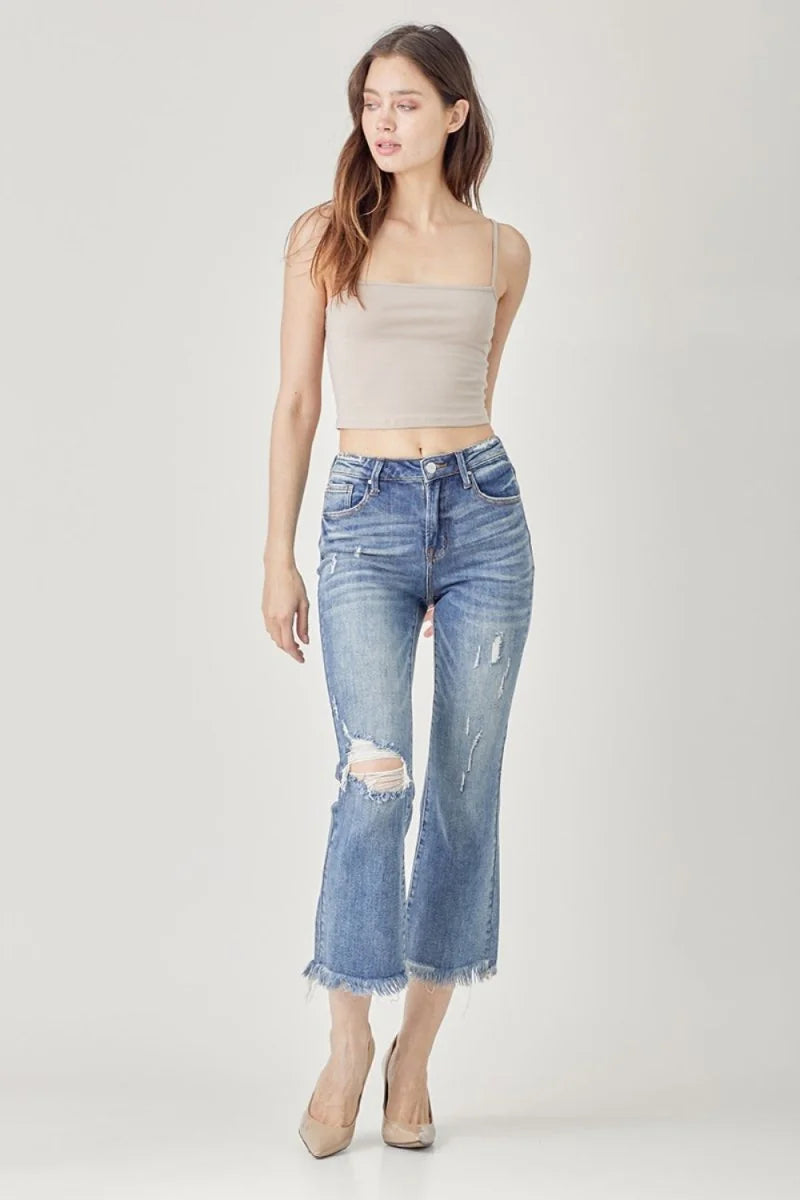 Distressed denim flare jeans with frayed hem, on model