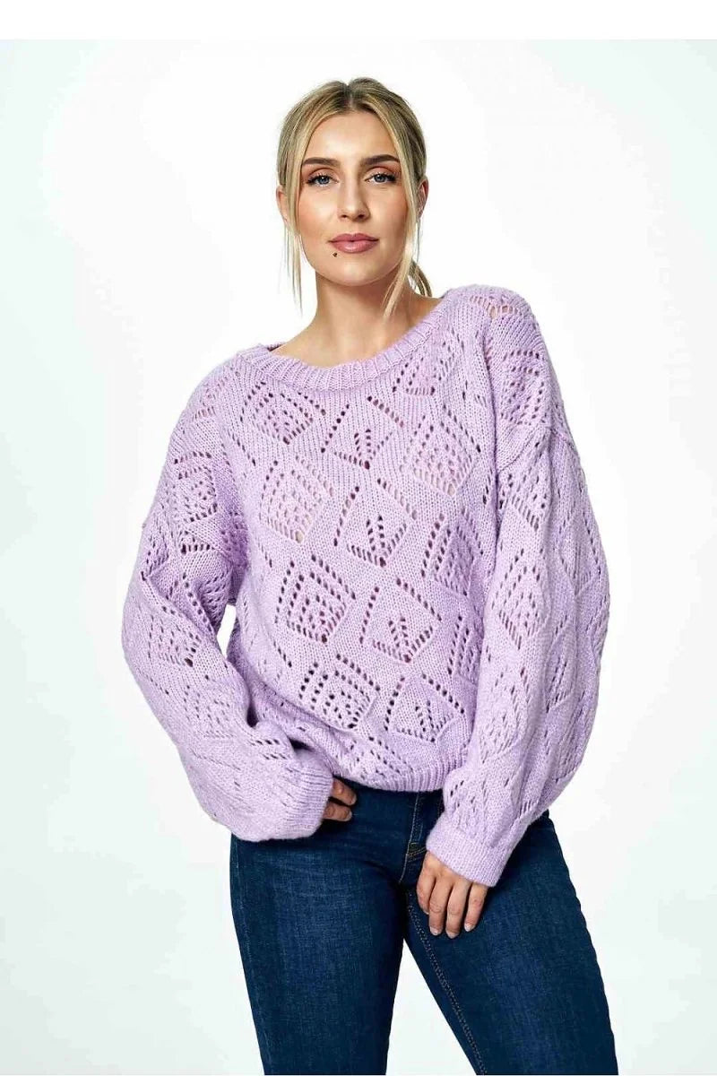 Lavender knit sweater with diamond pattern, long sleeves, on a model in dark wash jeans.