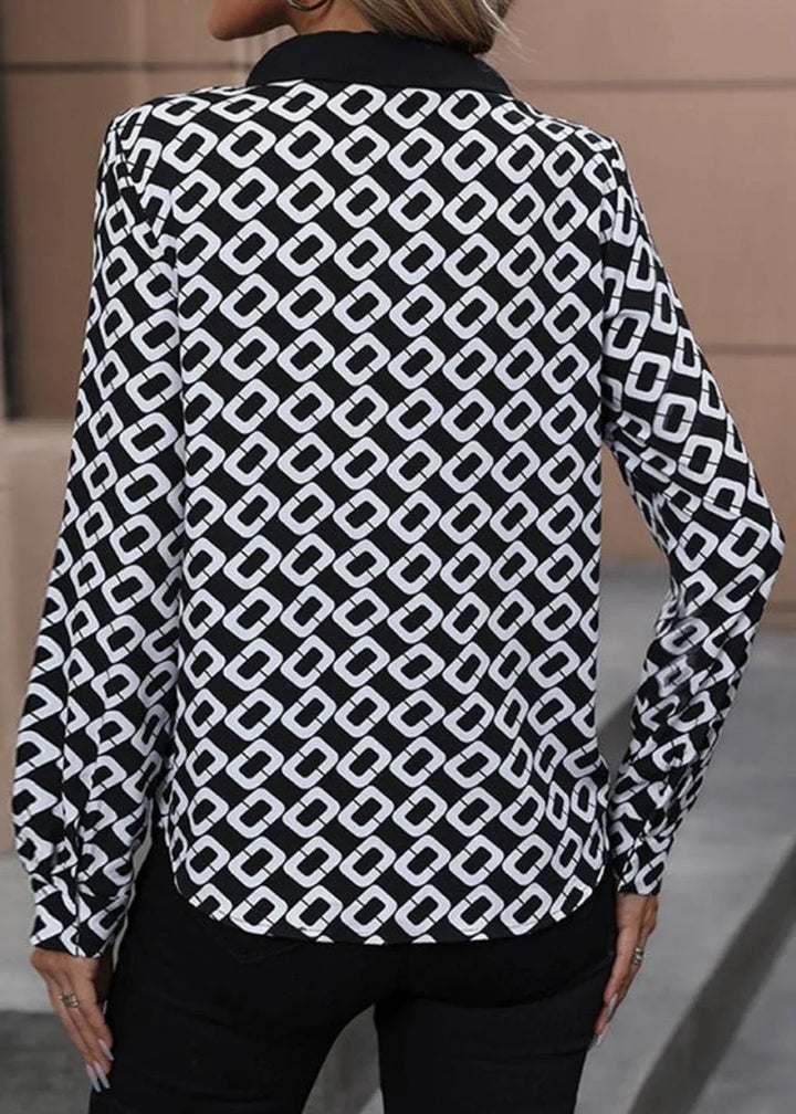 Black and white geometric print long-sleeve top with a collared neckline.