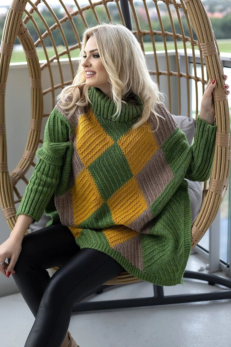 Woman in a green, mustard yellow, and taupe argyle knit poncho sweater with a cowl neck, wearing black leggings.