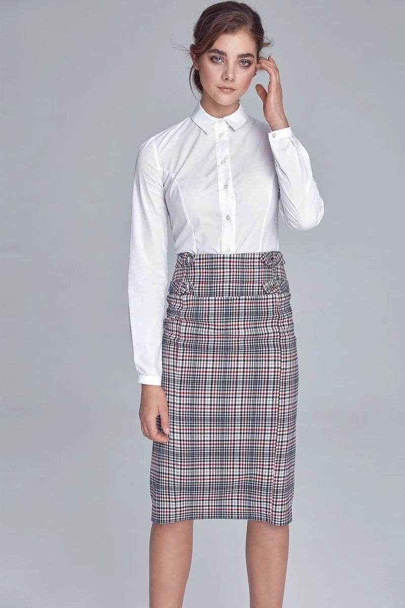 Woman in white collared shirt and red, navy, and white plaid pencil skirt with decorative buttons.