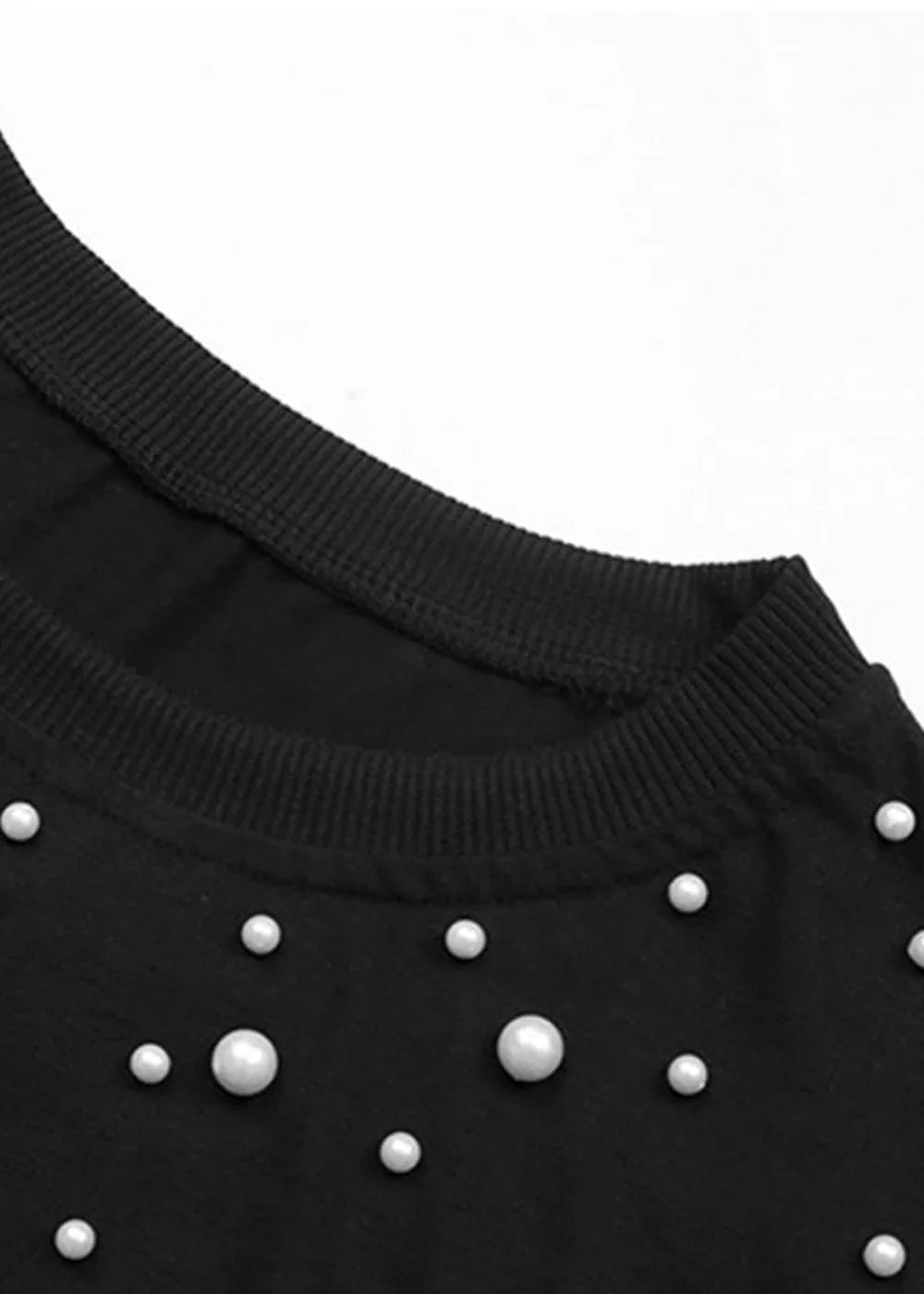 Black sweatshirt with pearl embellishments and ribbed neckline.