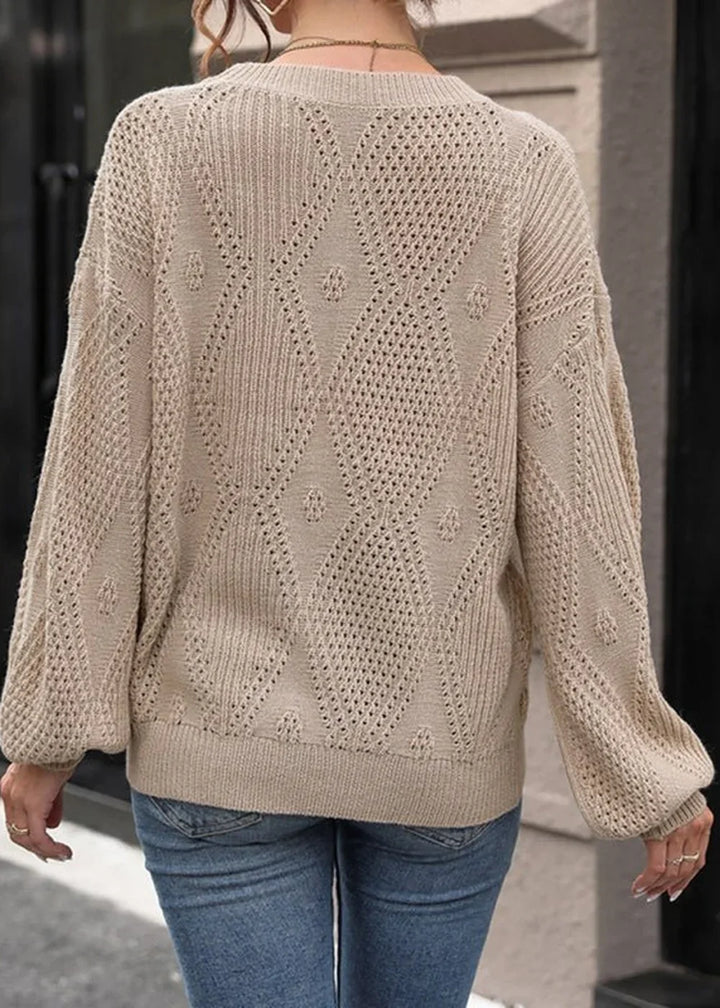 Beige knit sweater with diamond pattern and balloon sleeves, back view on model.