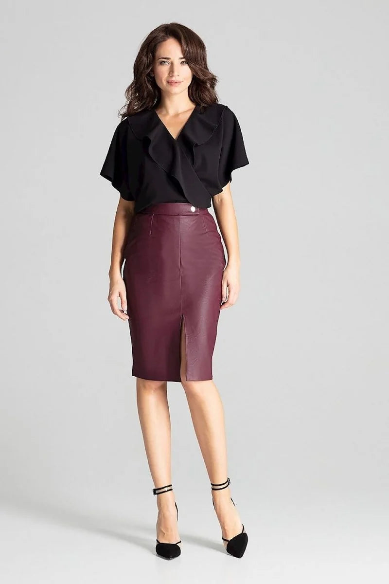 Burgundy faux leather pencil skirt with a front slit, worn by a model on a grey background.