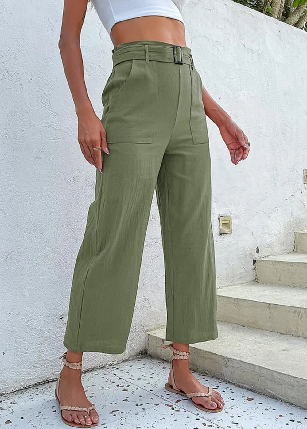 Olive green wide-leg pants with a belted waist and pockets on a model.
