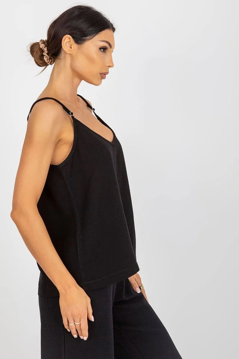 Black loose-fitting camisole with adjustable straps on a model.
