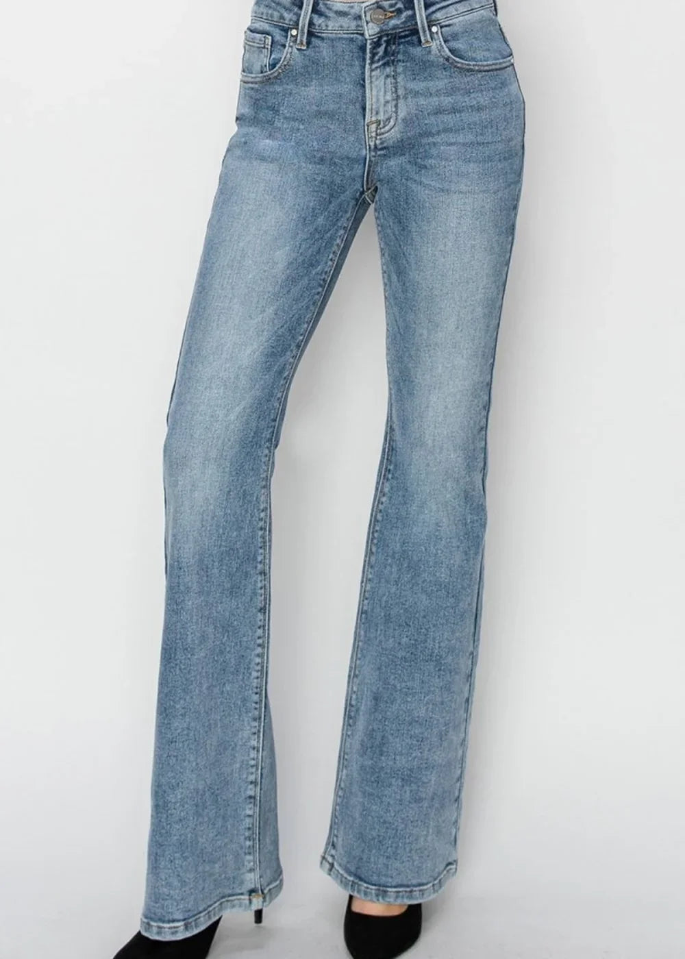 Light wash flared denim jeans with a slightly distressed texture and subtle fading.