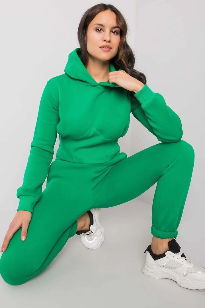 Green relaxed-fit cotton and polyester tracksuit with white sneakers, showing texture and detail.