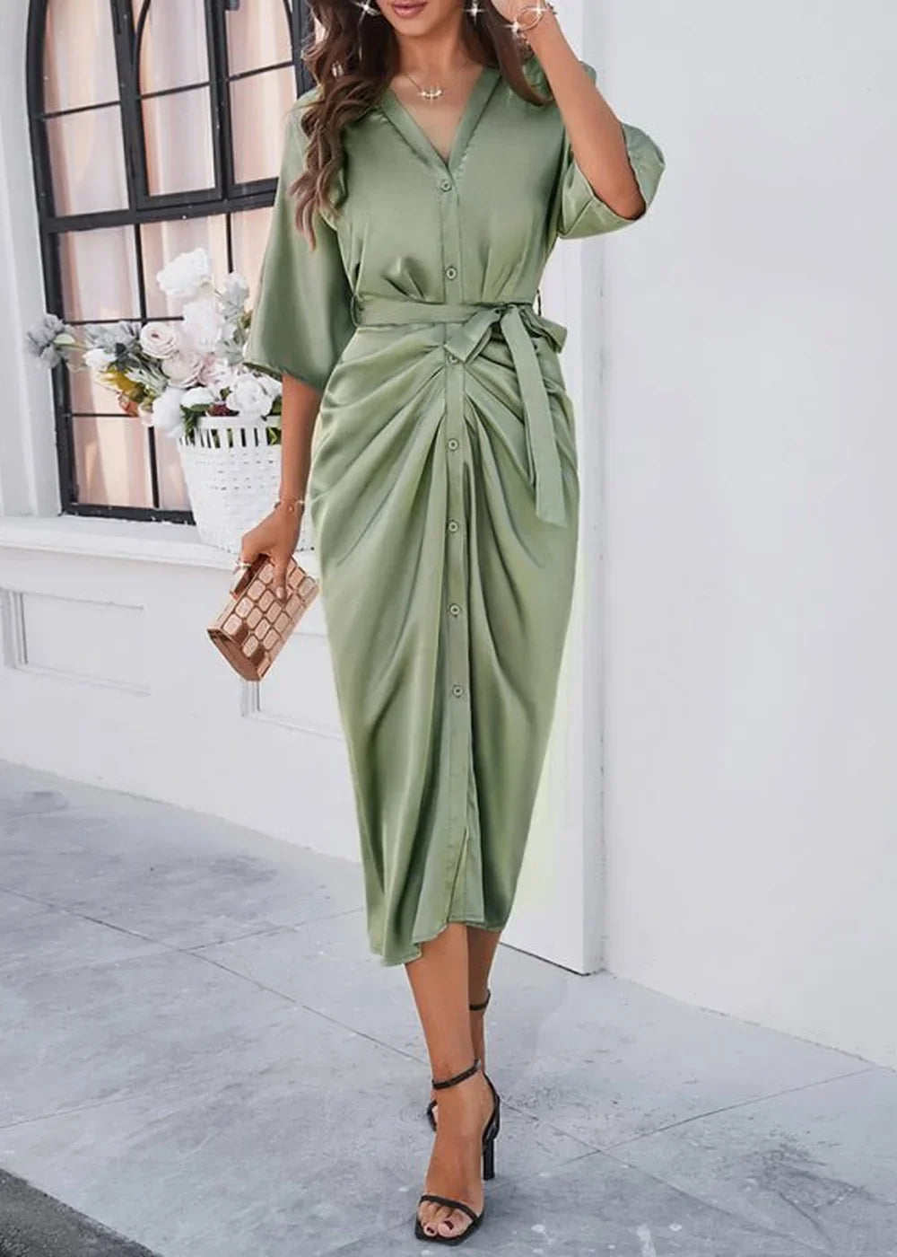 Sage green satin midi dress with a belted waist and button front, on a model.