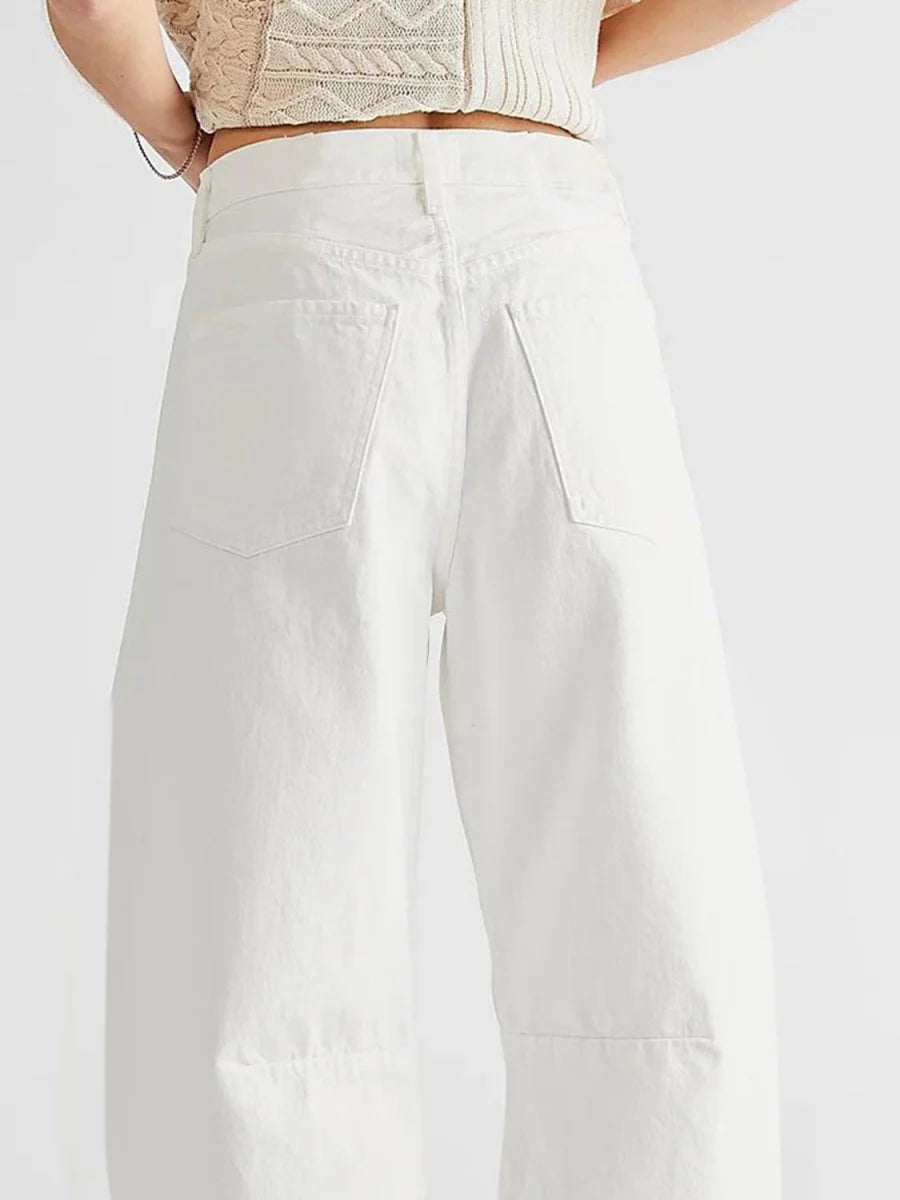 Close-up of the back of white, high-waisted, wide-leg pants with two back pockets.