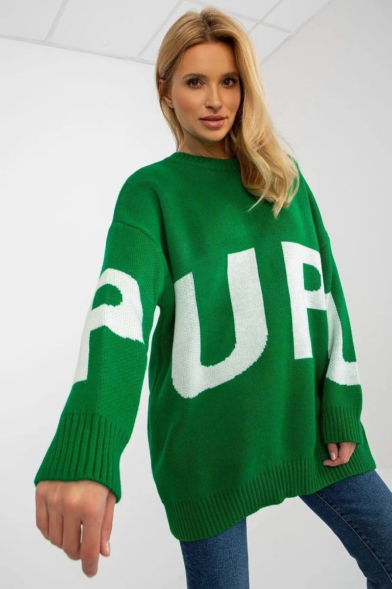 Green oversized sweater with large white "PURPLE" graphic print, on a model.