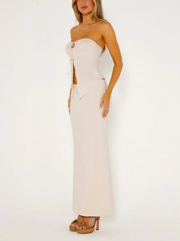 Cream strapless top with tie detail and matching high-waisted maxi skirt on model