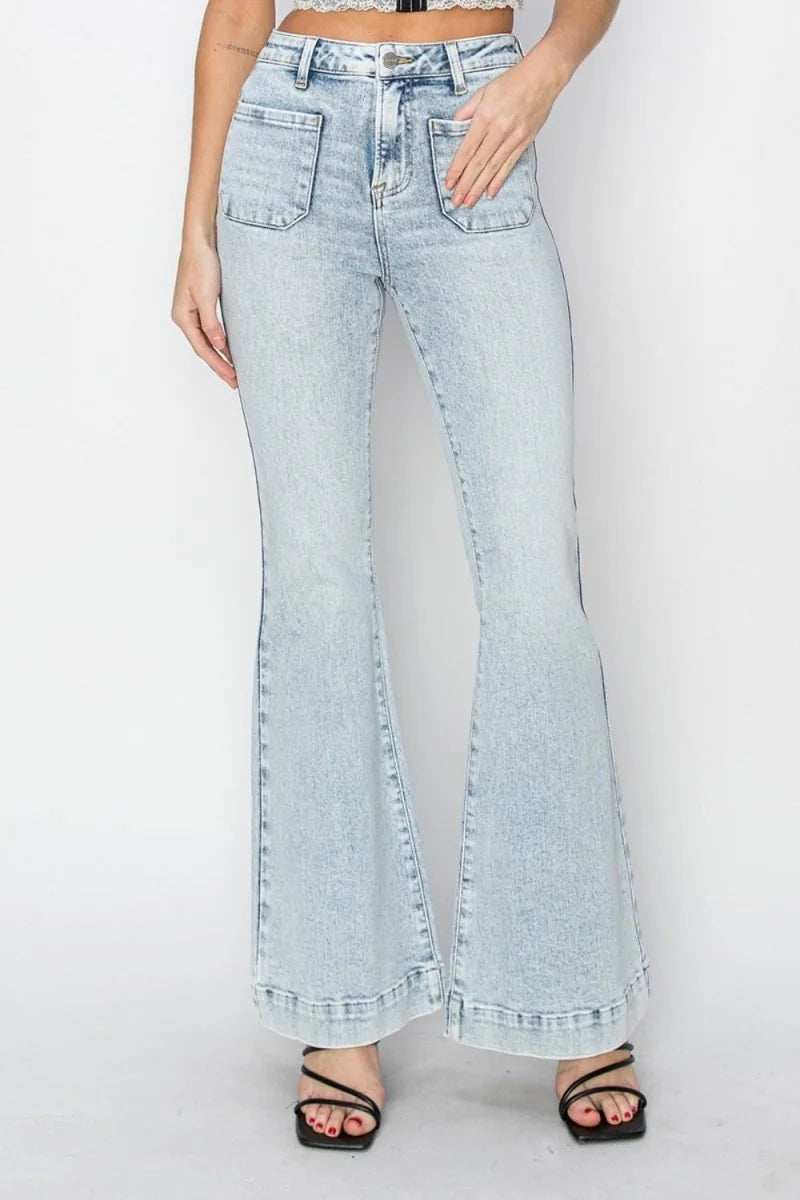 Light wash distressed denim flare jeans with large front pockets and a raw hem.