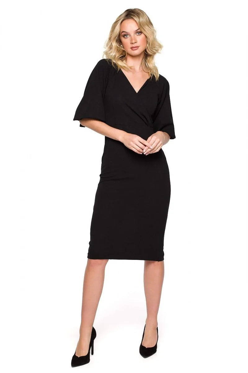 Black V-neck wrap dress with flutter sleeves, fitted at the waist and hips, on model.