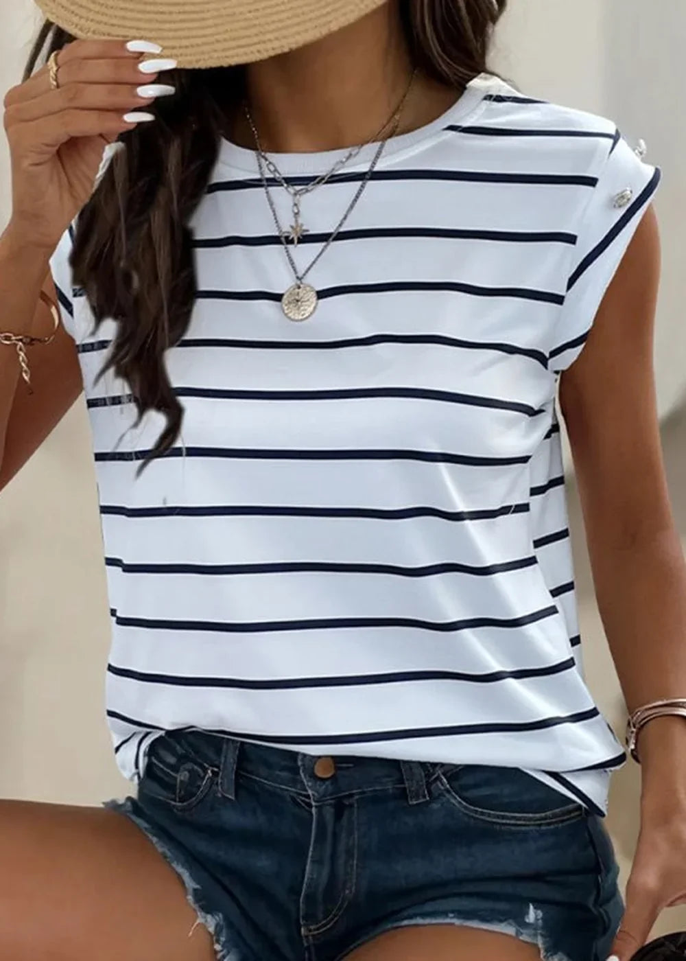 White and navy striped t-shirt with rolled cap sleeves and layered necklaces.