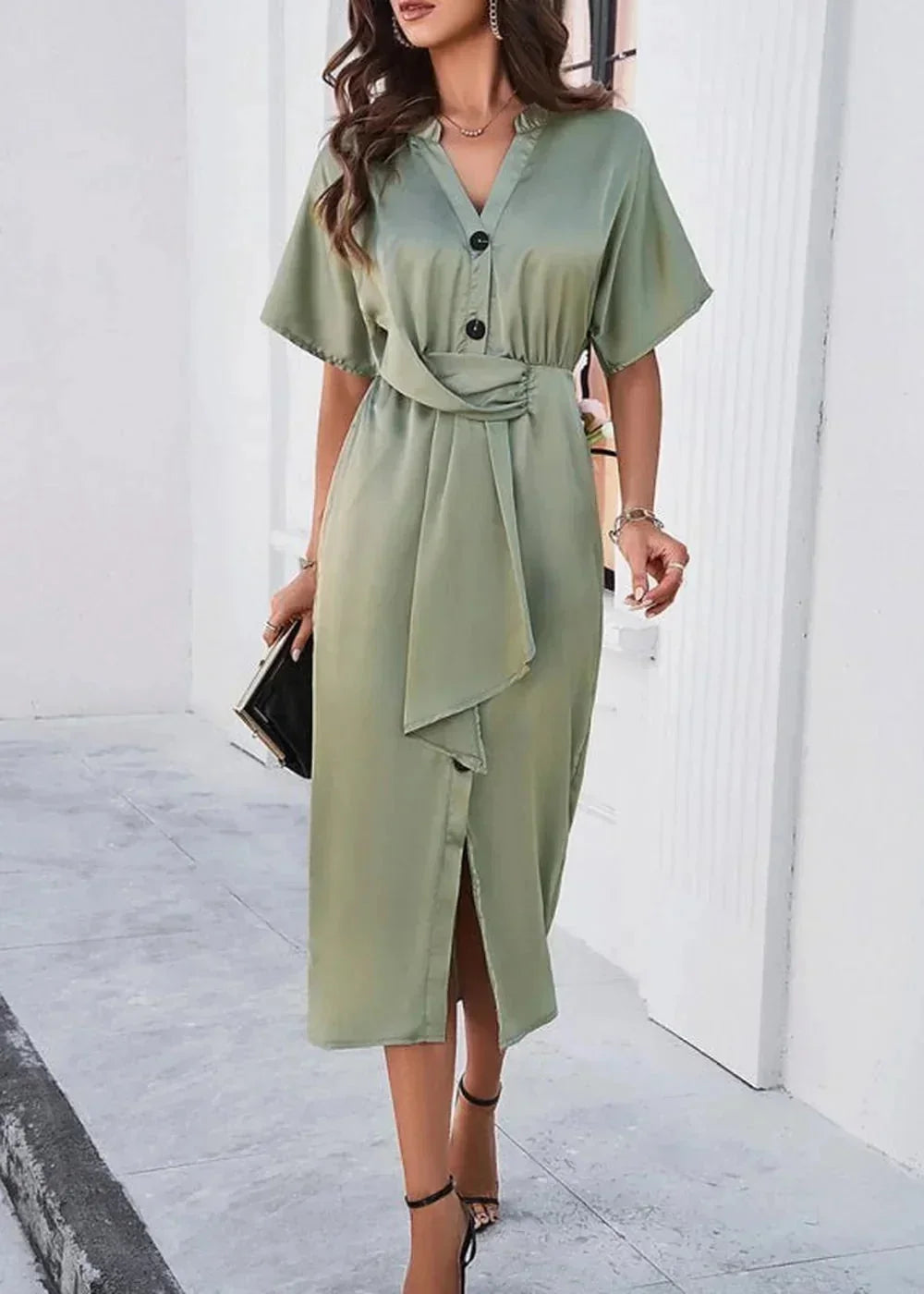 Sage green midi dress with V-neck, button detail, and a tie waist on a woman walking.