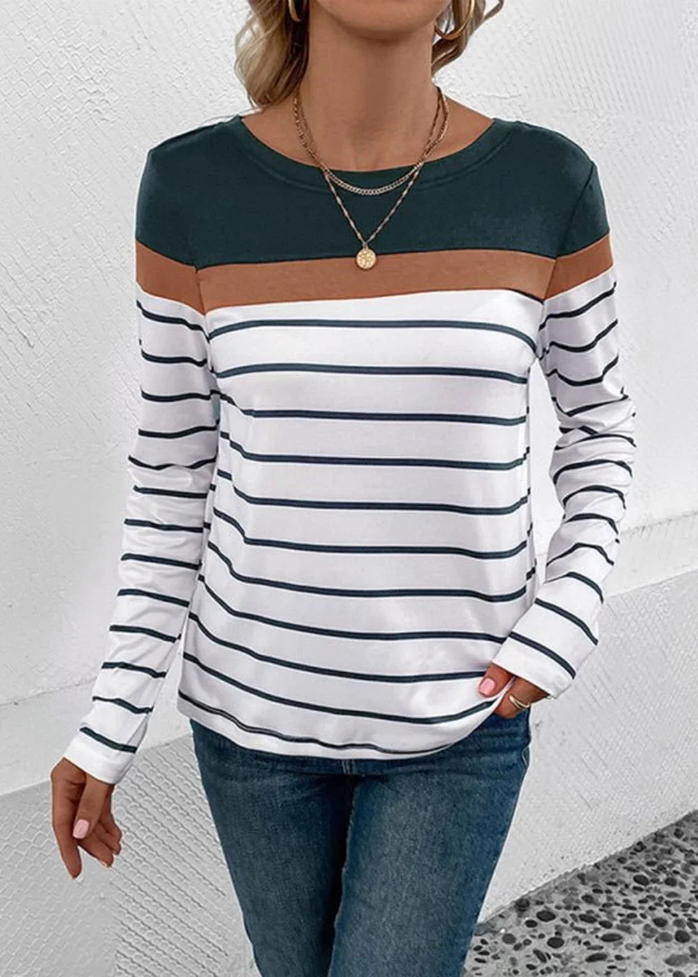 Long sleeve striped top with dark green and brown color blocking at the shoulders on a model.