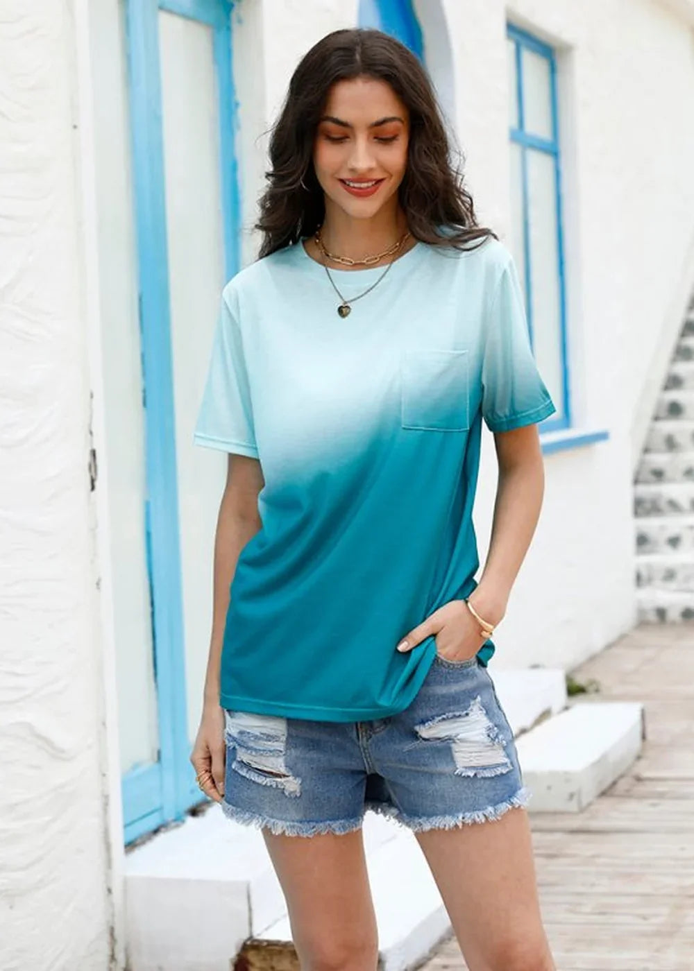 Teal and white ombre t-shirt with pocket detail and distressed denim shorts with frayed hem.