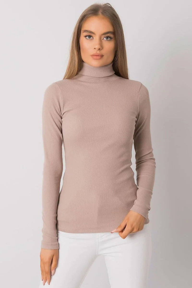 Fitted taupe ribbed turtleneck long-sleeve top on a model.