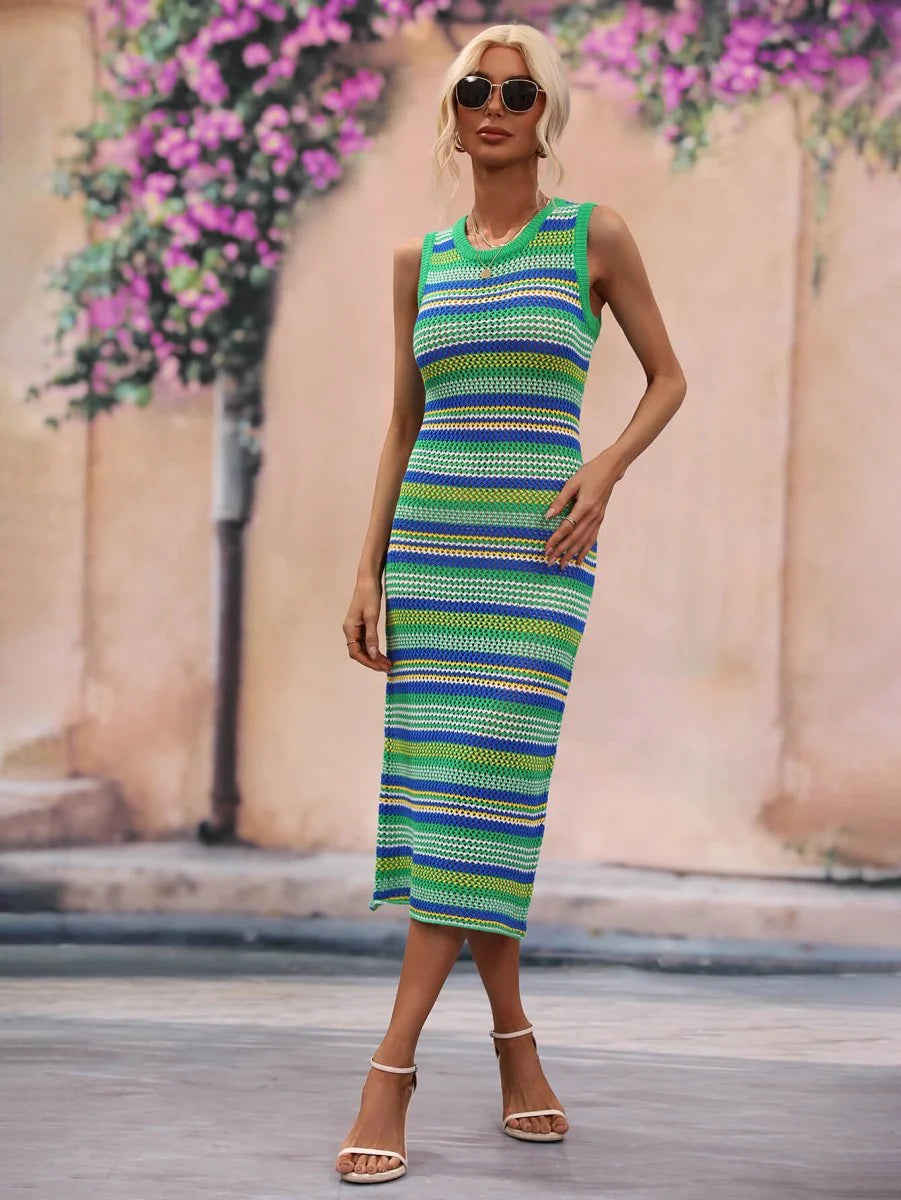 Woman in a sleeveless, knee-length acrylic knit dress with green, blue, and yellow horizontal stripes, paired with white s...