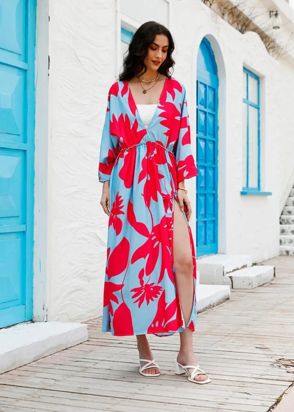 Light blue maxi dress with bold red floral print, V-neck, and high slit, worn by a model.