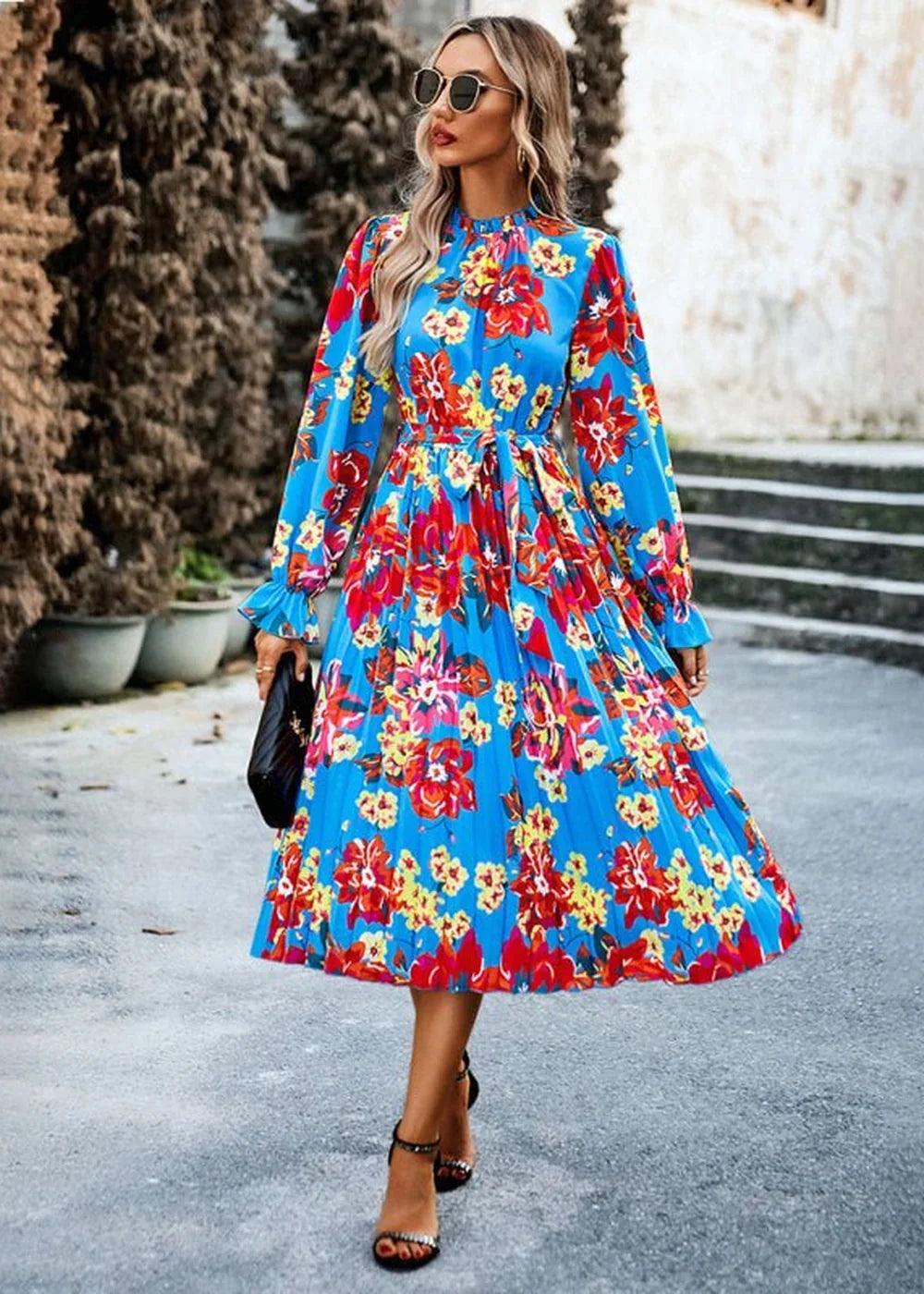 Blue floral print midi dress with pleated skirt and tie waist.