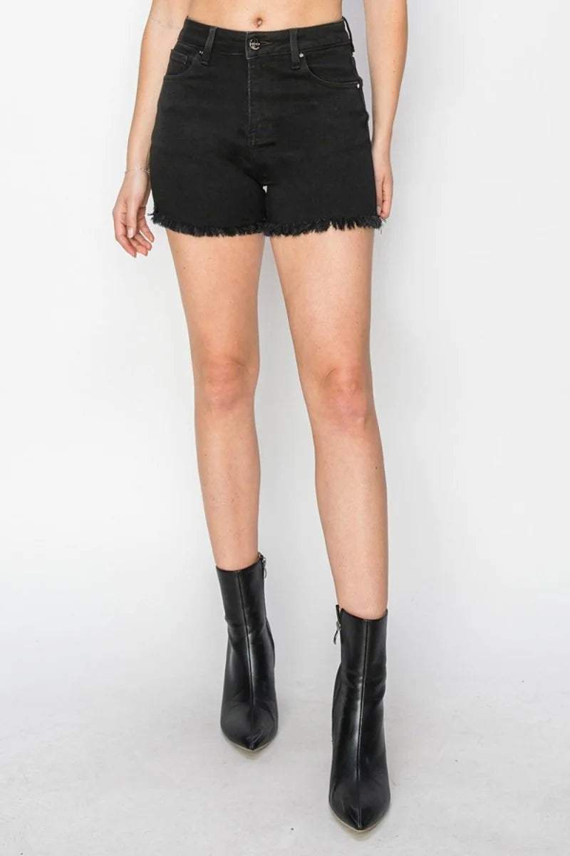 Black denim shorts with frayed hem and a regular fit on a model.