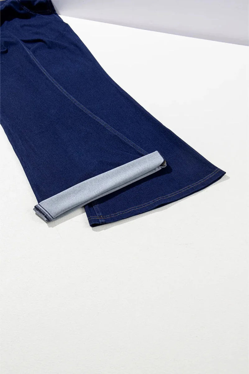 Dark wash denim pants with a rolled cuff and visible stitching detail.