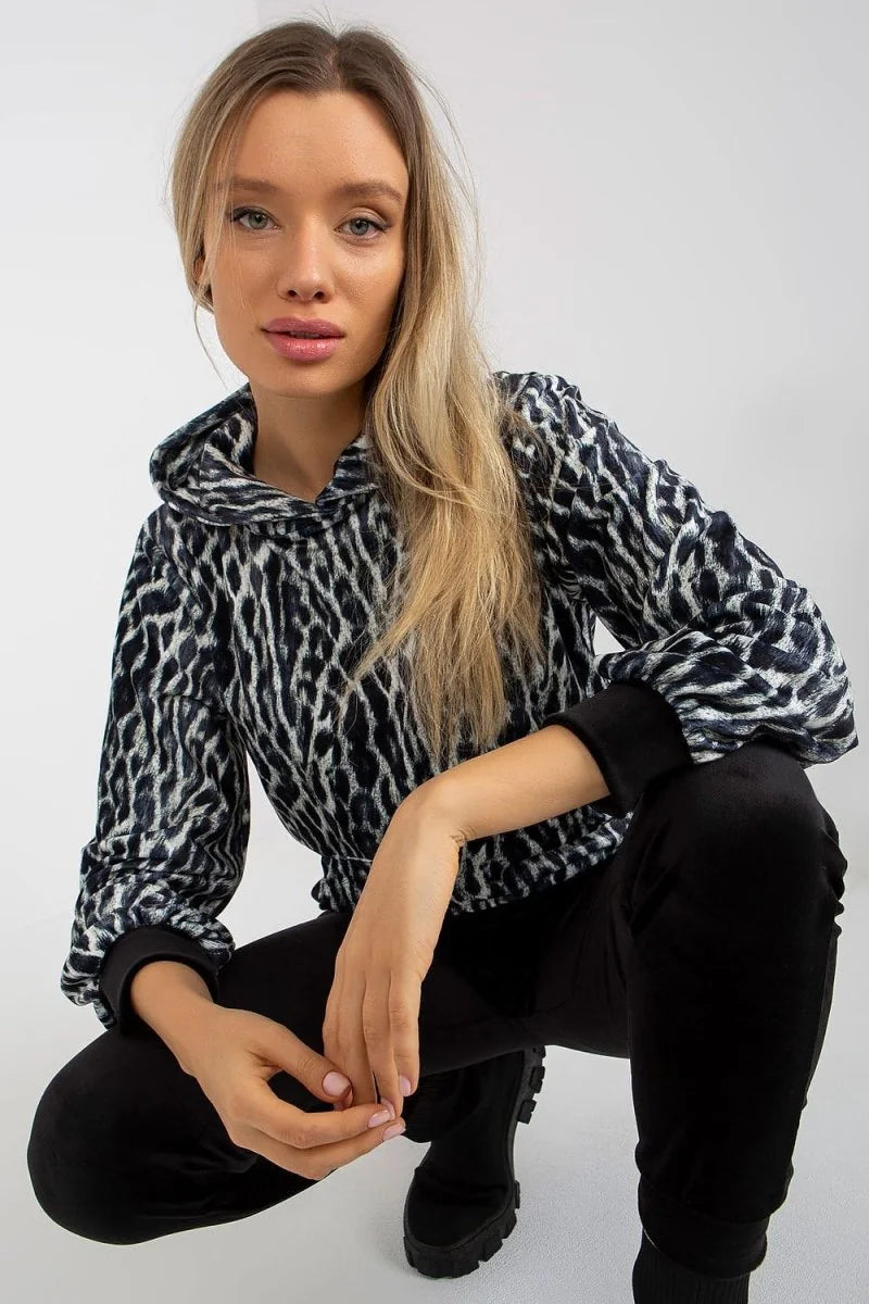 Black velour joggers with a drawstring waist and elastic cuffs, on a model.