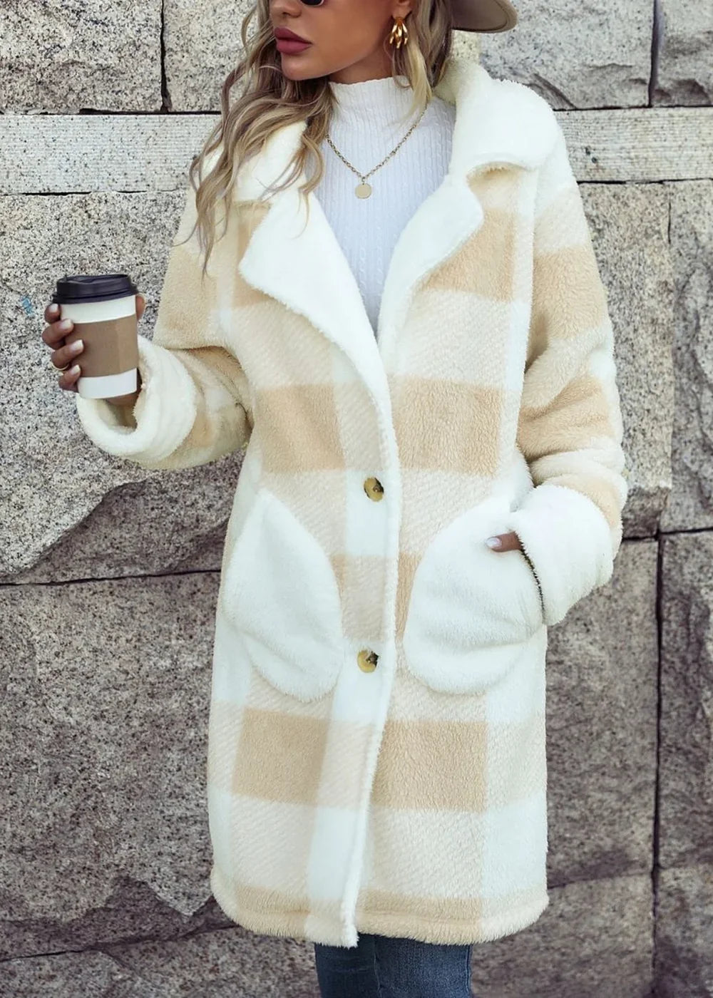 Plush beige and white plaid coat with oversized pockets and button closure on model.