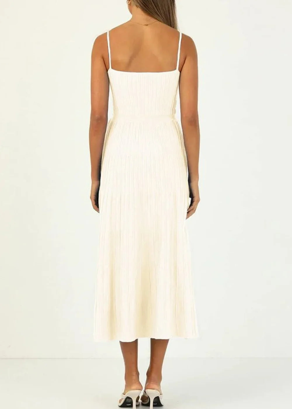 Cream ribbed knit midi dress with spaghetti straps, shown from the back on a model.