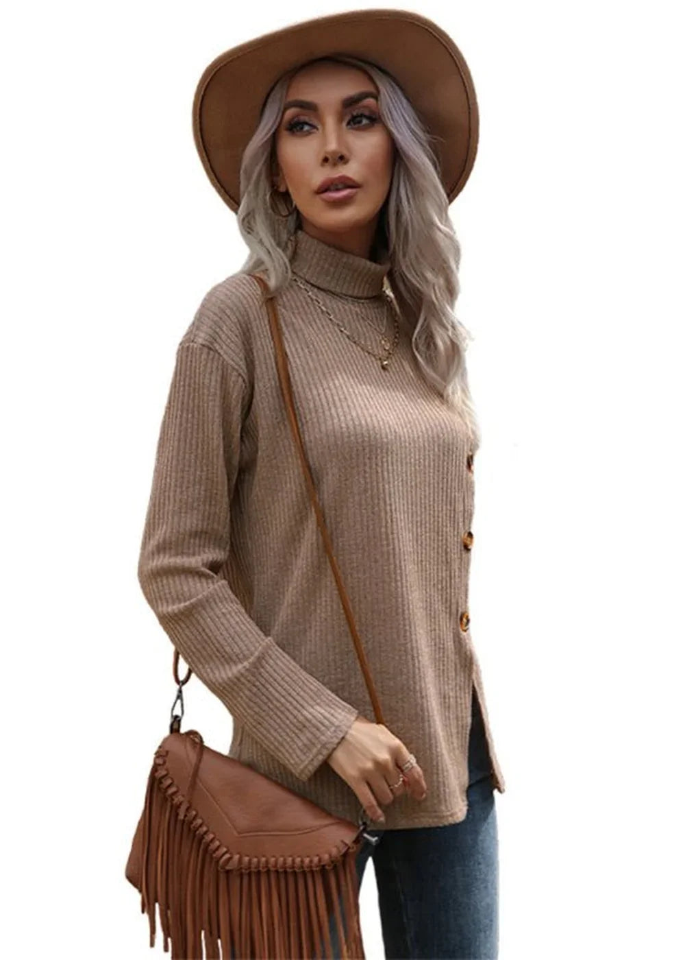 Tan ribbed knit turtleneck sweater with side buttons and fringe crossbody bag on model