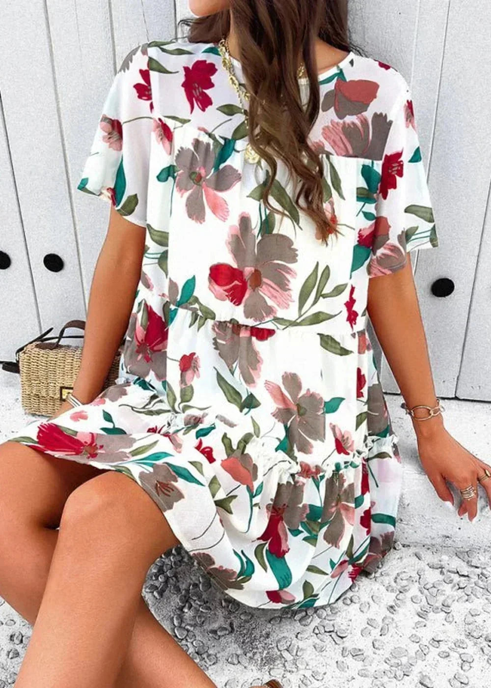White floral print tiered mini dress with short flutter sleeves.