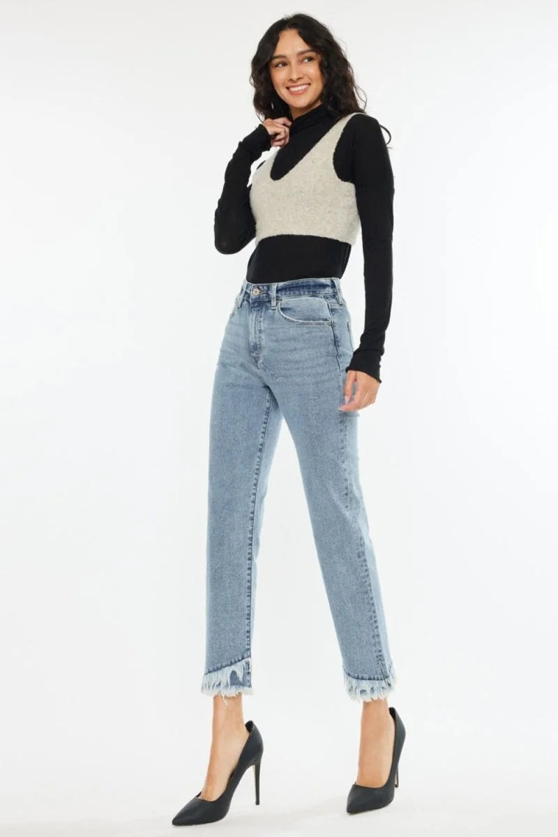 Light wash denim jeans with a frayed hem and a regular fit on a model.