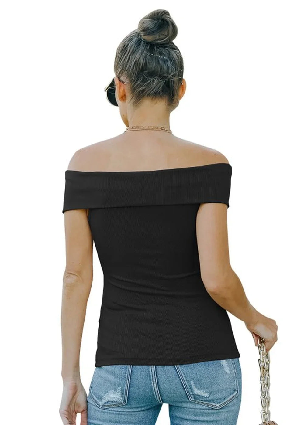 Black off-the-shoulder ribbed top on a model wearing distressed denim jeans.