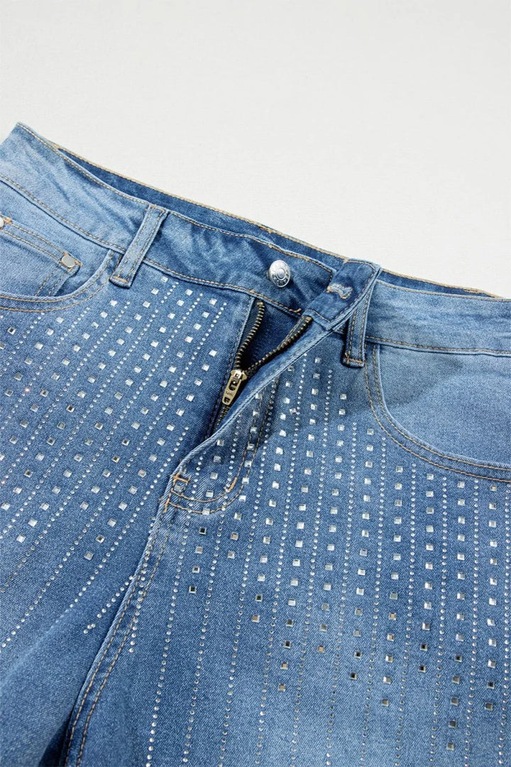 Light blue denim shorts with all-over rhinestone embellishments and a zip fly.