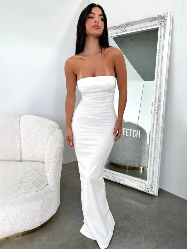 White strapless form-fitting maxi dress with a subtle sheen, full length on model.