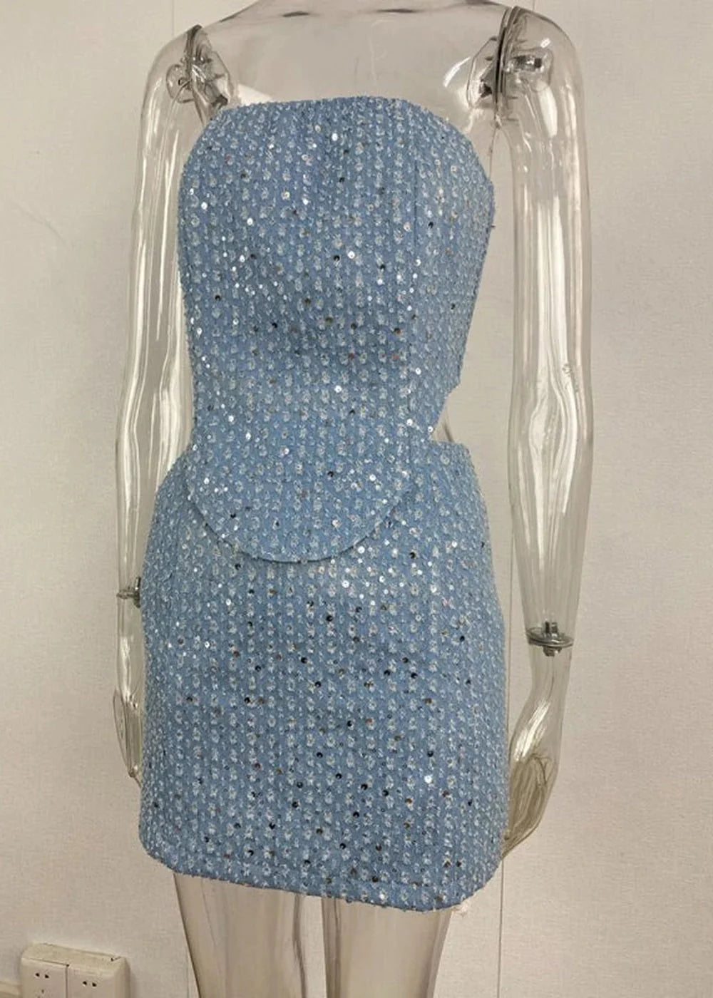 Blue sequined strapless mini dress with cut-out sides on a mannequin.
