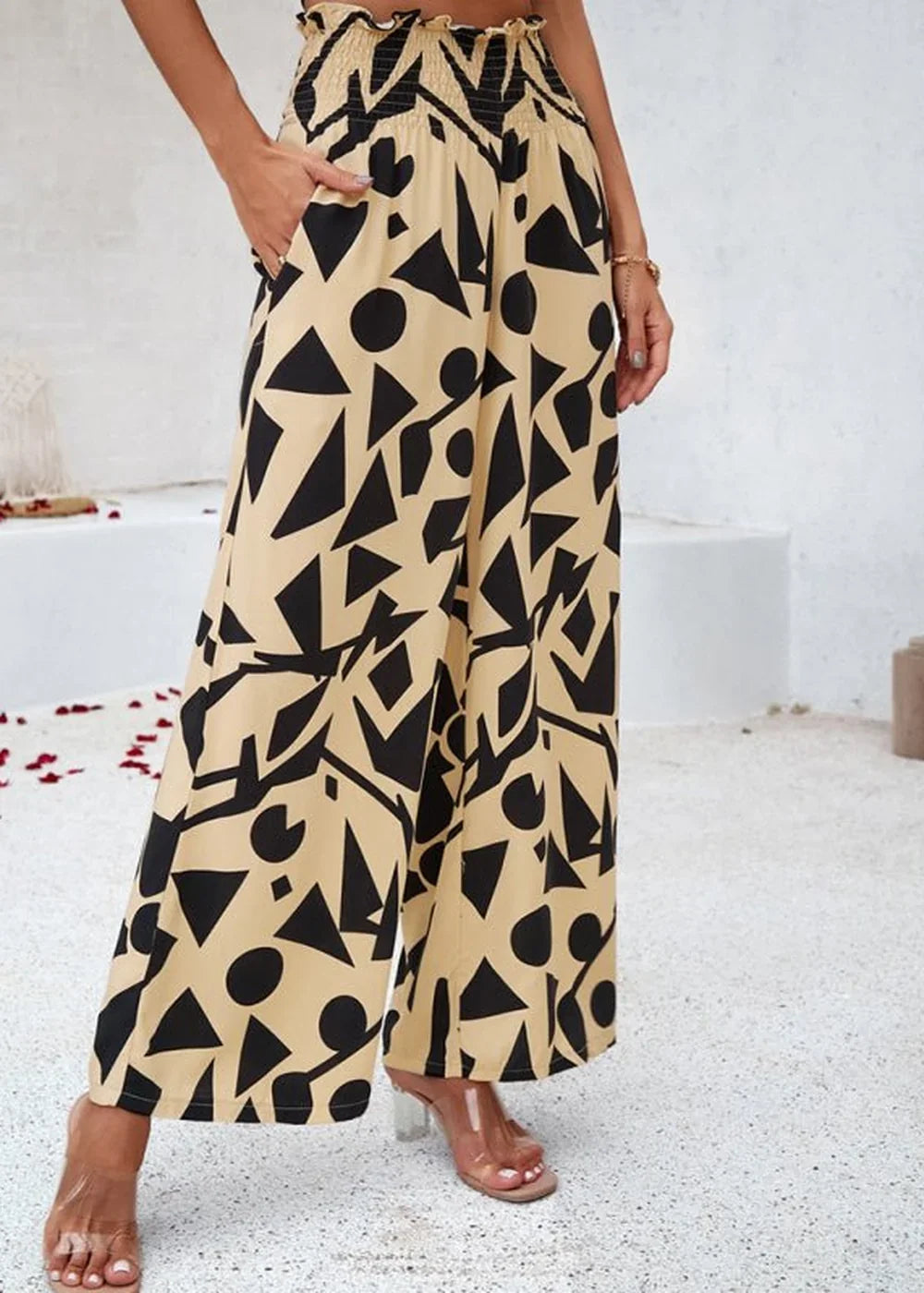 Tan and black geometric print wide-leg pants with a smocked waist.